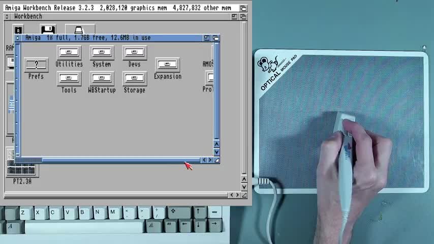 A pen-shaped optical mouse controlling the Amiga Workbench pointer