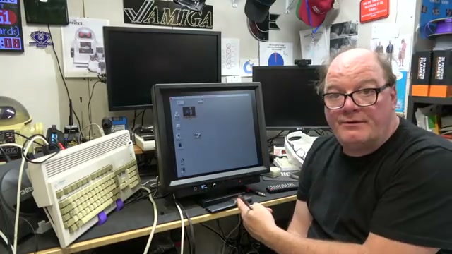 Chris Edwards beside the Checkmate IPS display showing an Amiga desktop
