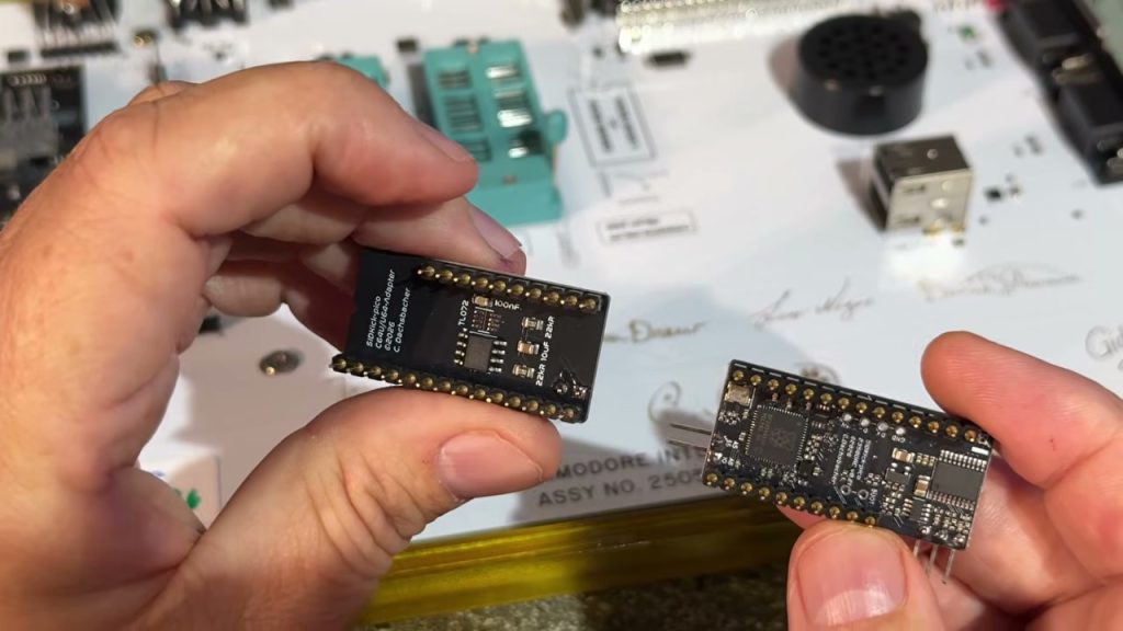 SIDKick Pico 2350 and ARM2SID boards held side by side above a Commodore 64 Ultimate